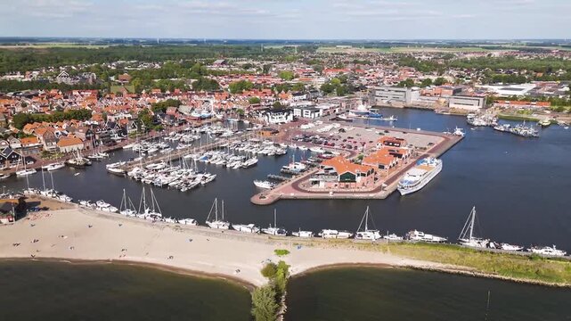 Aerial winter footage of Urk fishing village harbor and lighthouse