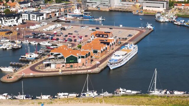 Aerial winter footage of Urk fishing village harbor and lighthouse