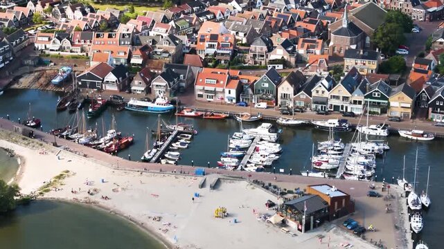 Aerial winter footage of Urk fishing village harbor and lighthouse