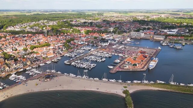 Aerial winter footage of Urk fishing village harbor and lighthouse