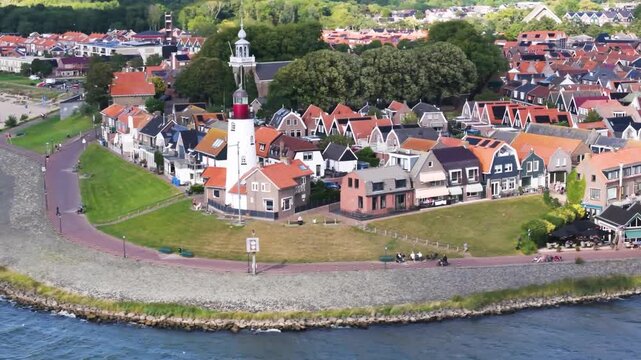Aerial winter footage of Urk fishing village harbor and lighthouse
