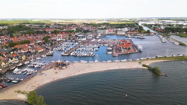 Aerial winter footage of Urk fishing village harbor and lighthouse