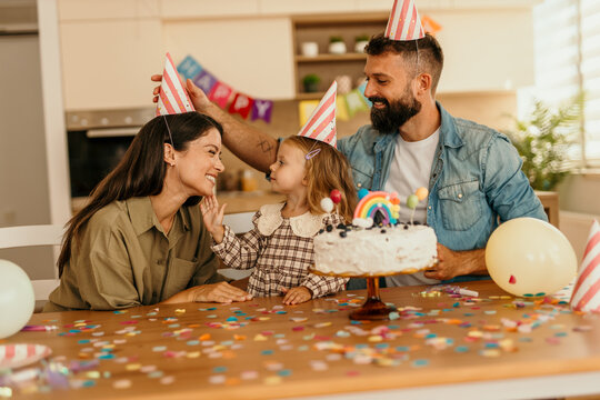 Child celebrating milestone moment with cake and confectionery