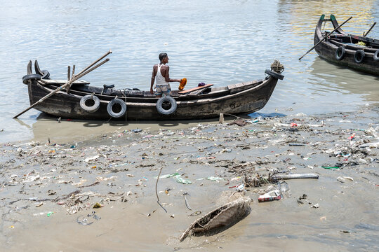 Chattogram, Bangladesh - 15 August 2025: View of a lone man navigating the polluted Karnafuli River with his modest boat, a stark contrast to the vibrant life it once fostered.