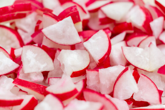 Chopped Ripe Radis Roots, Fresh Red White Radish Cut Close-up, Pile of Diced Red Radishes, Sliced Salad Ingredient. Natural Healthy Food Background.
