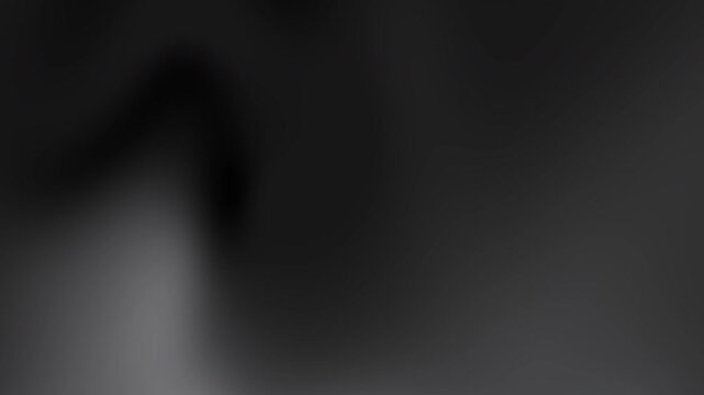 Blurry dark shape against a gray gradient background. Suitable for abstract backgrounds, mysterious concepts, and template designs with a modern aesthetic.