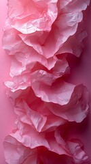Obraz premium Crumpled soft pink paper or fabric creates a dynamic vertical wave of textured layers