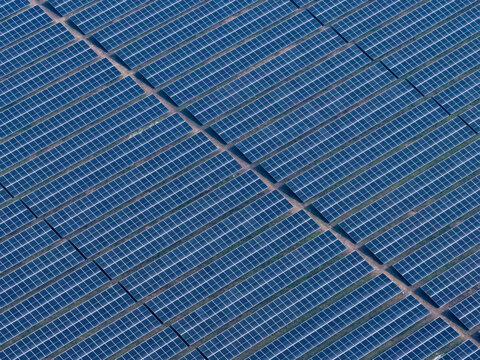 Aerial view of a vast expanse of solar panels stretching across the landscape, capturing sunlight in a grid-like pattern, Gaibandha, Rangpur Division, Bangladesh.