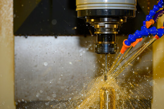 Advanced CNC milling of brass material using oil coolant lubrication and a ball nose end mill for high-precision surface finishing.