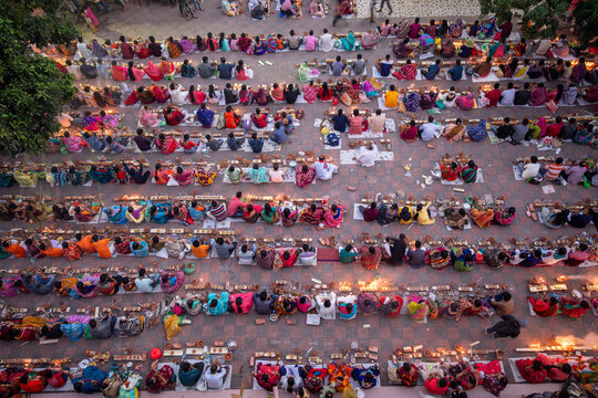 Aerial view of rows of people seated on the ground, arranged in neat lines, participating in a mass dining event, Narayanganj, Dhaka Division, Bangladesh.