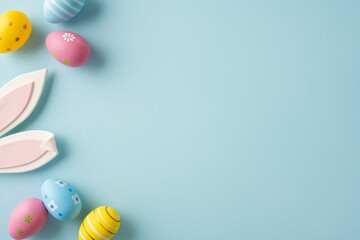 Happy Easter greeting scene featuring pastel decorated egg and playful bunny ears arranged on a...