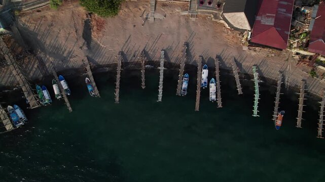 Overhead of janky docks on tropical lake, tour boats, Lake Atitlan, Guatemala.