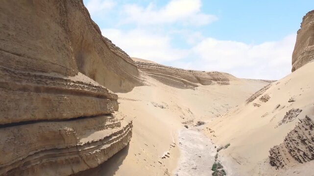 Drone aerial view,Ca&ntilde;on del Zapa (known as The Canyon of the Lost) is located, in the area called Montegrande, in Ica Peru, blue sky 4K