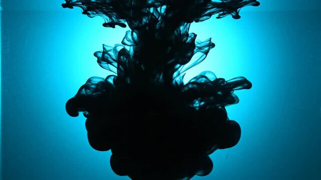 Black Ink Cloud Descending Through Turquoise Water