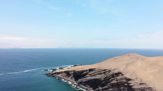 Drone aerial view, blue sea and clear sky blue mountain and boat in Paracas National Park, Peru 4k.