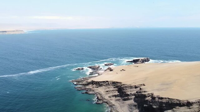 Drone aerial view, blue sea and clear sky blue mountain and boat, kayak in Paracas National Park, Peru 4k.