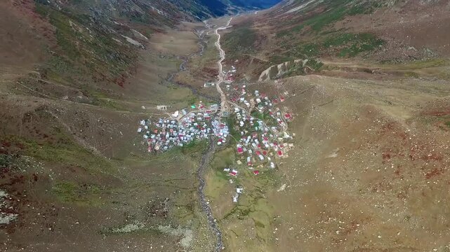 Aerial view of a remote village in Ladakh, Jammu and Kashmir, Asia. Surrounded by arid mountains and dry valleys, the settlement reflects traditional architecture and high-altitude Himalayan culture.