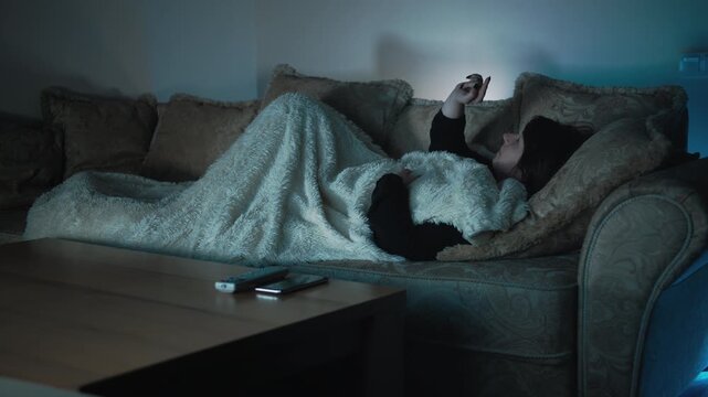 Evening Relaxation: Woman Reclining on the Couch and Interacting with an Invisible Gadget via Her Contact Lenses