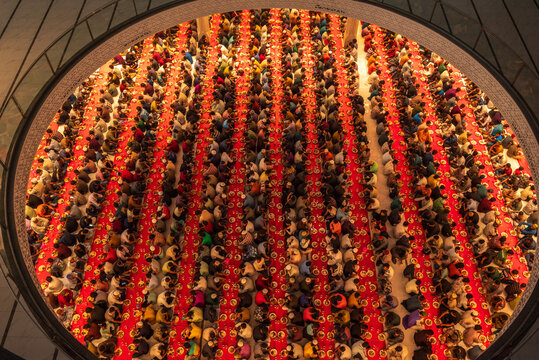 Dhaka, Bangladesh - 25 February 2026: Aerial view of rows of people gathering for Iftar at Baitul Mukarram, a vibrant tapestry of colors and unity seen from above.