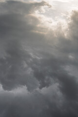 Fototapeta premium Dramatic sunset sky with dark storm clouds and soft light, moody atmosphere before rainfall