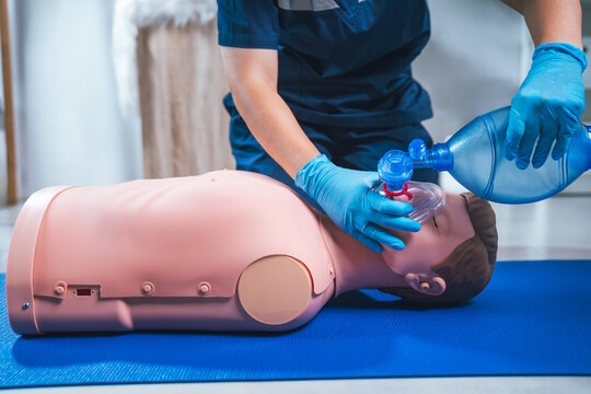 CPR Training, Healthcare Worker Practicing Artificial Respiration On CPR Dummy With Ambu Bag Featuring Essential Emergency Training For Rescue Breathing And First Aid Intervention