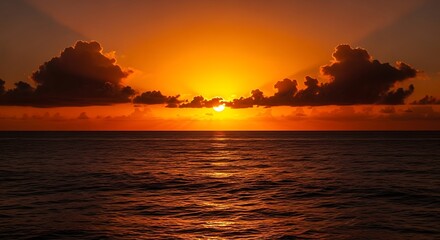 Naklejka premium A breathtaking ocean sunset, with the sun's rays peeking through dark clouds over the water