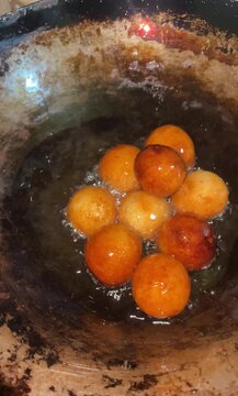 fried gulab jamun in a frying pan