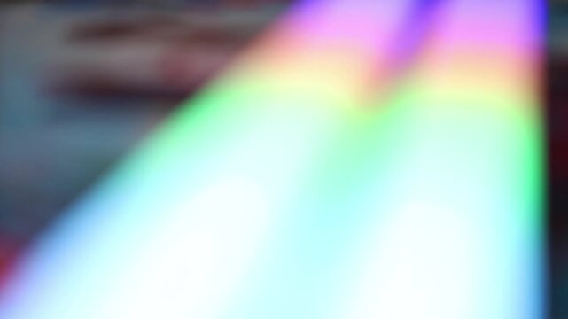 Abstract neon bokeh background with flowing colorful lights in soft focus.