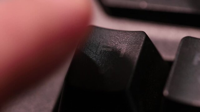 Pressing F1 button for help and support on computer keyboard, macro shot of human finger.