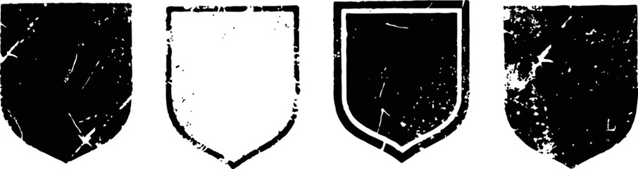 Naklejka premium set of four vintage distressed shield shapes with rough textured edges and grunge effects