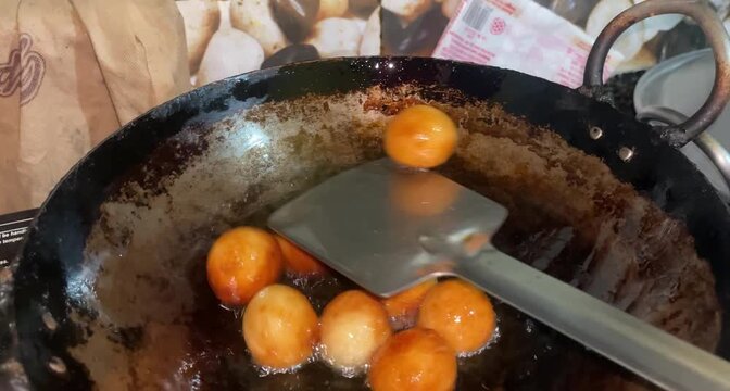 fried gulab jamun in a pan