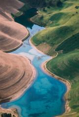 Fototapeta premium Aerial view of the river, Conceptual Sustainable Landscape and Winding River for Magazine Cover, Eco-friendly Biophilic Agriculture and Water Resilience