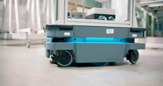 Autonomous mobile robot carrying goods in modern industrial warehouse