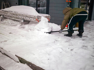 man lifting a shovel with snow