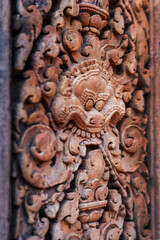 Naklejka premium Detail of bas-relief stone carvings in Banteay Srei temple, the citadel of women in Angkor, Siem Reap, Cambodia