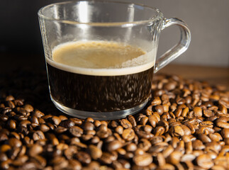 A cup of coffee on the coffee beans