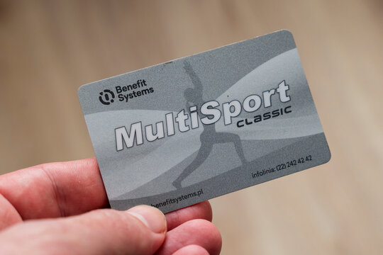 Warsaw, Poland - Feb 26, 2026: A close-up of a hand holding a MultiSport card from Benefit Systems showcasing its brand and design. The card symbolizes fitness access and wellness benefits.