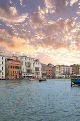 Venice palazzos on Grand Canal with motorboat at sunset