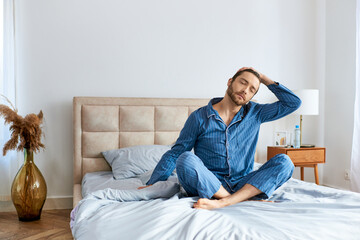 Fototapeta premium Relaxed man enjoying a peaceful morning moment at home in comfortable surroundings