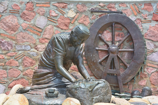 PUERTO VALLARTA MEXICO:  Washer Woman bronze statue by Jim Demetro, placed in 2008 near the Cuale River bridge and in front of the Molino de Agua condos along the malecon boardwalk 