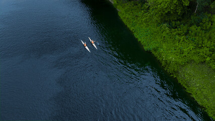 two swimmers floating down the river the view from the drone © Polivan