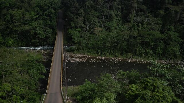Aerial above Rio Barranca river in Costa Rica with highway bridge in jungle