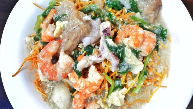 Mie kering or Mie titi, Indonesian food from Makassar served with seafood, meatballs, vegetables and sliced chicken meat. Food photography