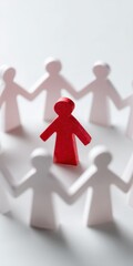Red figure female caucasian adult standing inside circle of white paper people symbolizing prominence inclusion and unity