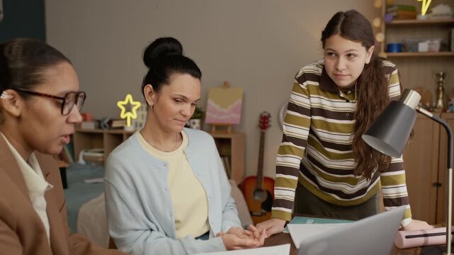 Caucasian mother sitting near female tutor and involving in conversation with daughter and tutor who sharing her plans and thoughts about lessons