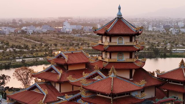 Aerial view of famous buddhist pagoda in da nang, vietnam with the city skyline during a magical golden hour sunset, quan the am pagoda