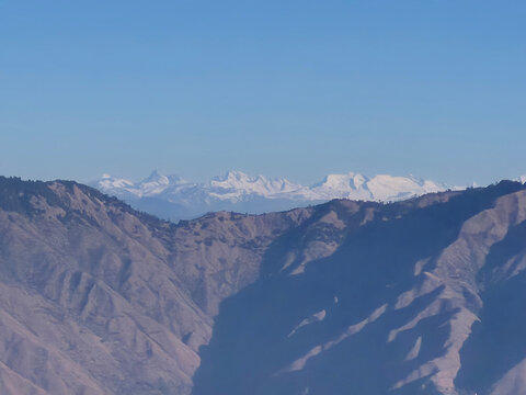 Snow Mountain Range View from Mussoorie Uttarakhand, India. Mussoorie offers panoramic views of the Garhwal Himalayan range featuring snow-capped peaks. From viewpoints like Lal Tibba & Landour