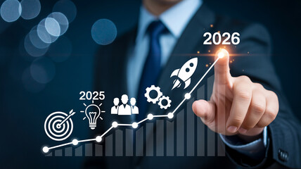 Obraz premium Businessman pointing at a rising graph with icons representing goals, ideas, teamwork, and a rocket launching towards the year 2026