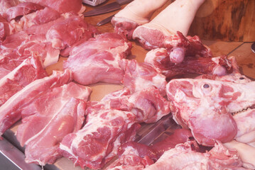 Many pieces of pork on table at market close up