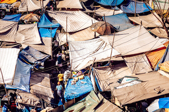 Kampala, Uganda - 28 March 2024: View of a crowded marketplace under a patchwork of vibrant tents, where shadows dance and colors burst, creating a lively urban tapestry.